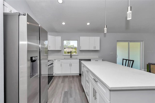 17468 SW 36th Ter, Ocala, FL 34473 - kitchen with a sink, light countertops, appliances with stainless steel finishes, and light wood-style floors
