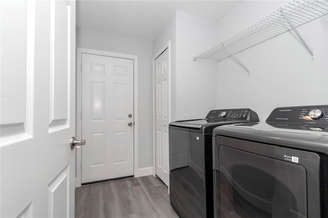 17468 SW 36th Ter, Ocala, FL 34473 - laundry room with washer and clothes dryer, light wood finished floors, and laundry area