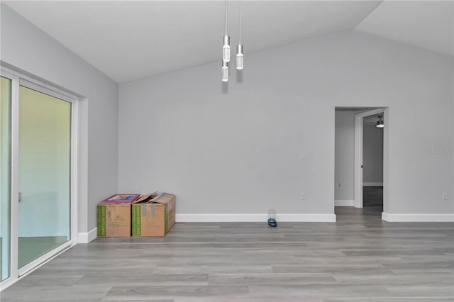 17468 SW 36th Ter, Ocala, FL 34473 - unfurnished dining area with wood finished floors, baseboards, and vaulted ceiling