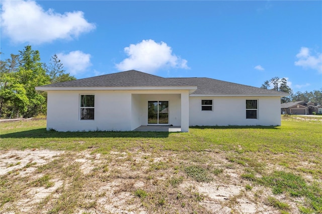 17468 SW 36th Ter, Ocala, FL 34473 - rear view of house featuring a yard, roof with shingles, and stucco siding
