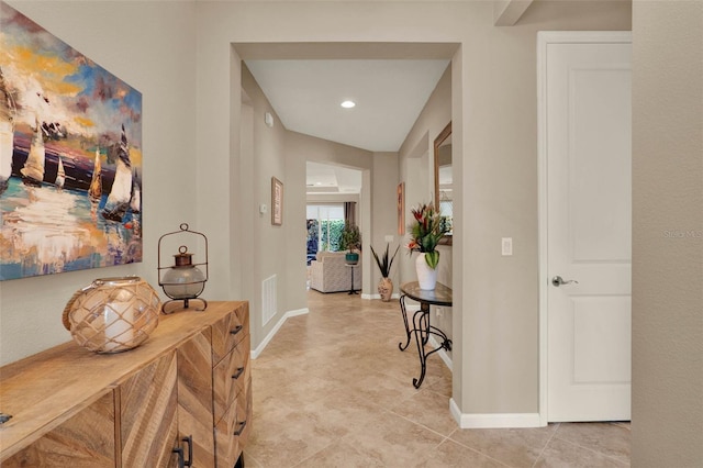 corridor with visible vents, baseboards, recessed lighting, and light tile patterned floors