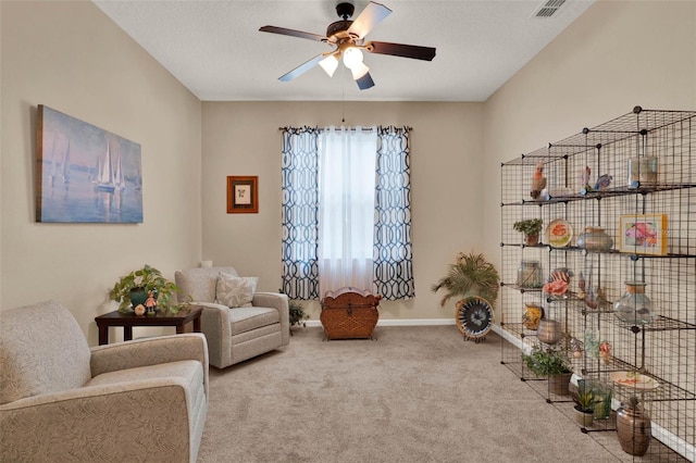 sitting room featuring visible vents, baseboards, a ceiling fan, and carpet