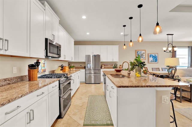 kitchen featuring stainless steel appliances, recessed lighting, white cabinets, and a sink