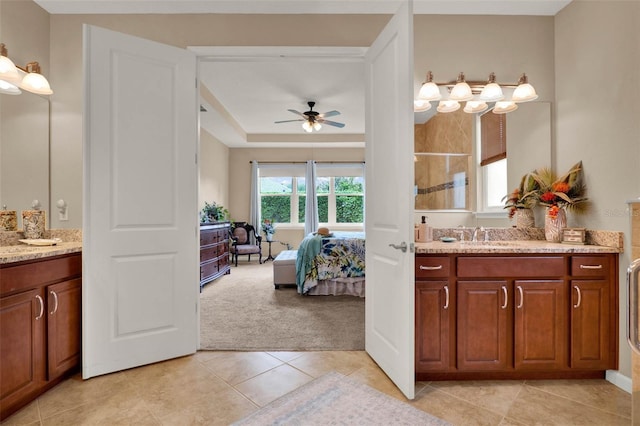 full bath featuring tile patterned floors, two vanities, ceiling fan, and walk in shower