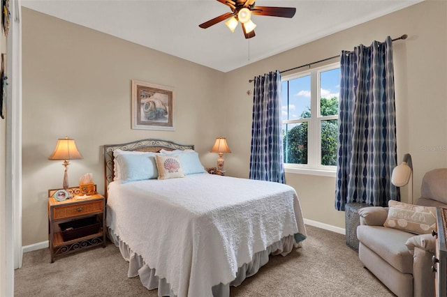 carpeted bedroom featuring baseboards and ceiling fan