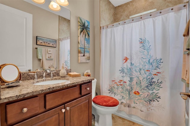 full bath with tile patterned floors, toilet, vanity, and shower / bath combination with curtain