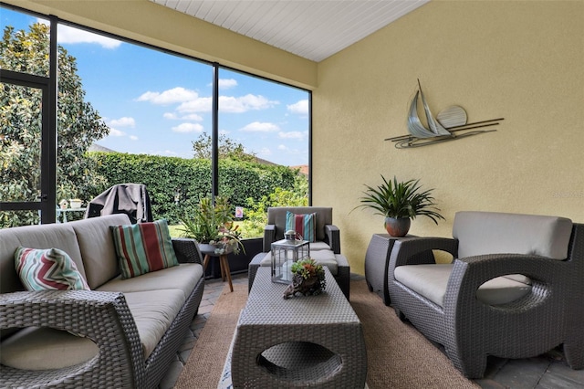 sunroom / solarium with an outdoor hangout area and a healthy amount of sunlight