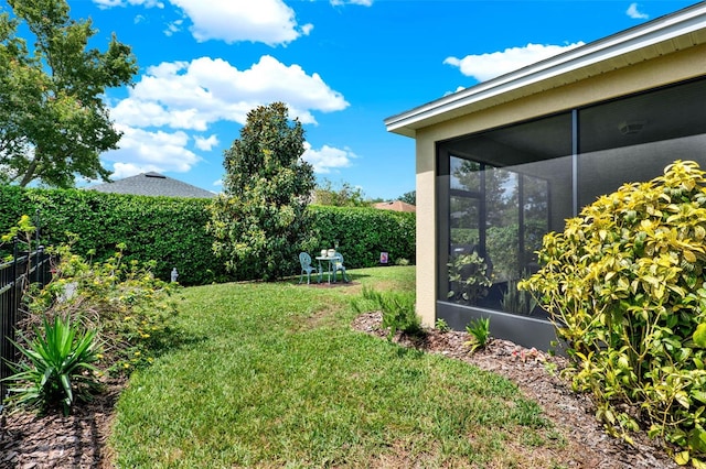 view of yard featuring a sunroom and fence private yard
