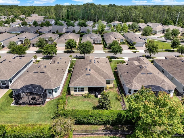 drone / aerial view with a view of trees and a residential view