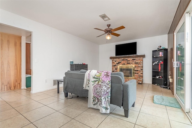 living area featuring visible vents, a ceiling fan, and light tile patterned floors