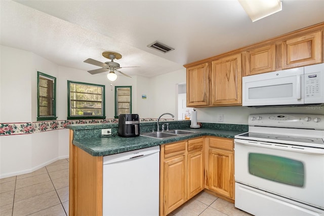kitchen featuring a sink, visible vents, a ceiling fan, white appliances, and light tile patterned floors