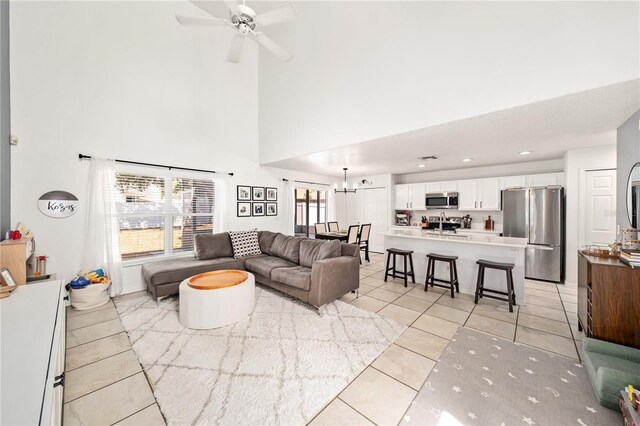 1415 Sherbourne St, Winter Garden, FL 34787 - living area with light tile patterned floors, a towering ceiling, and ceiling fan with notable chandelier