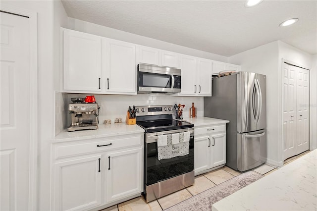 1415 Sherbourne St, Winter Garden, FL 34787 - kitchen featuring stainless steel appliances, tasteful backsplash, white cabinets, and recessed lighting
