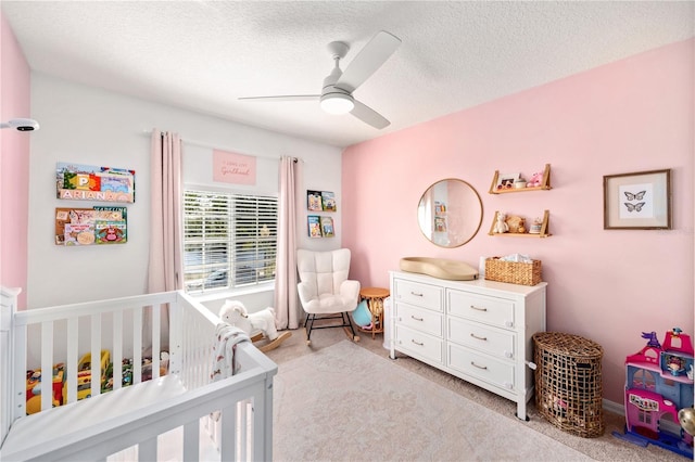 1415 Sherbourne St, Winter Garden, FL 34787 - bedroom featuring light carpet, a ceiling fan, a textured ceiling, and a nursery area