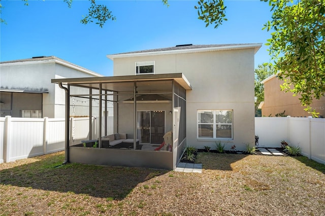 1415 Sherbourne St, Winter Garden, FL 34787 - rear view of house with a yard, stucco siding, a fenced backyard, and a sunroom