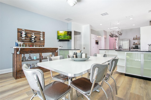 dining room featuring recessed lighting, visible vents, and light wood-style flooring
