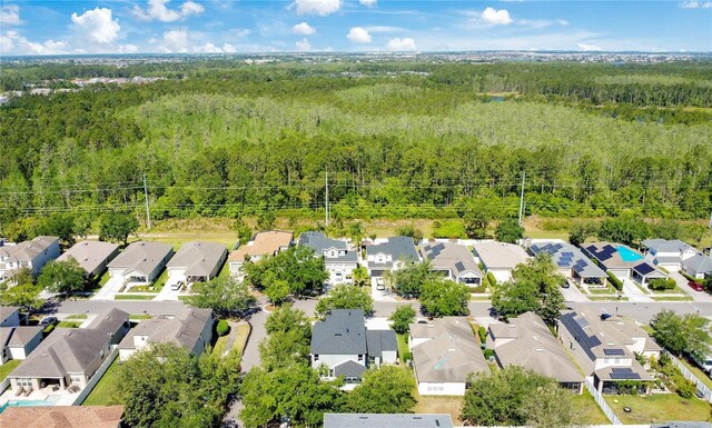birds eye view of property featuring a residential view and a forest view