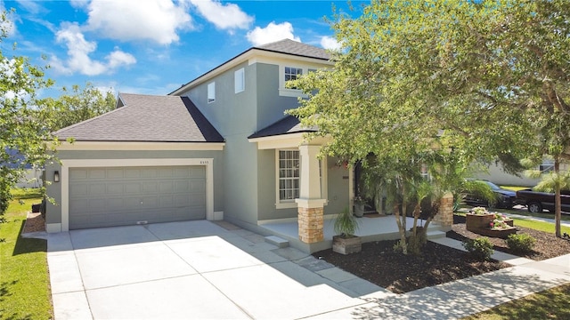 view of front facade featuring an attached garage, driveway, stucco siding, and a shingled roof