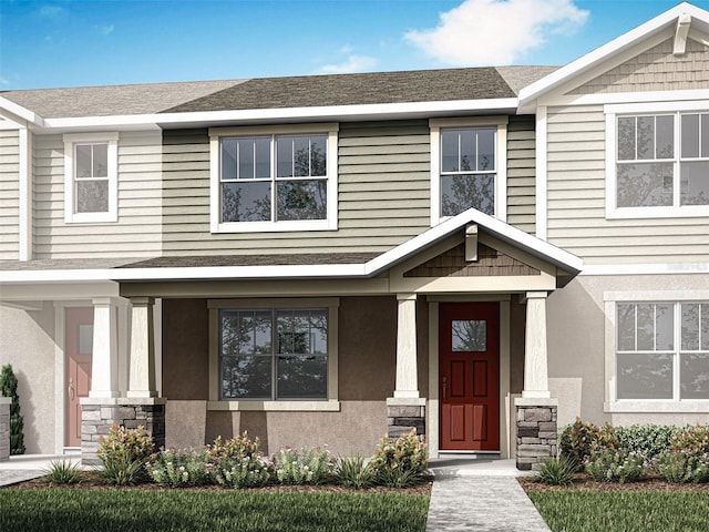 view of front of house with stucco siding and stone siding