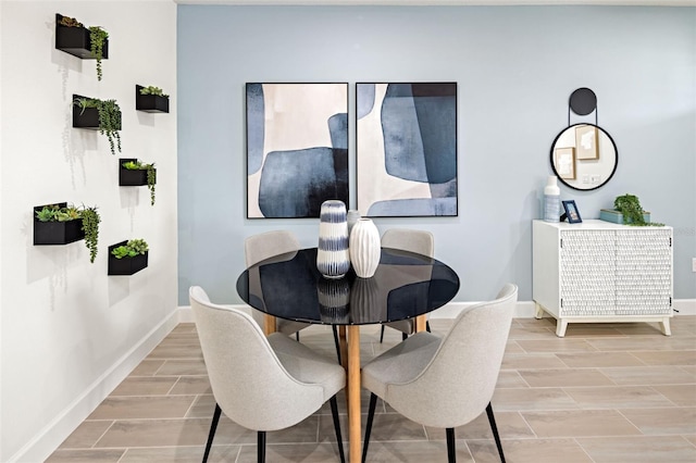dining area featuring baseboards and wood finish floors