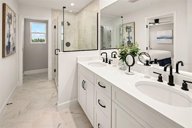 bathroom featuring double vanity, marble finish floor, a sink, and baseboards