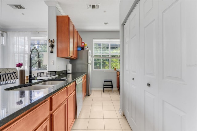 kitchen with a sink, baseboards, plenty of natural light, and dishwasher