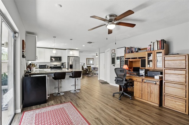 office featuring ceiling fan, baseboards, wood finished floors, and recessed lighting