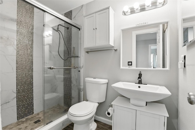 full bath with a shower stall, toilet, and a sink