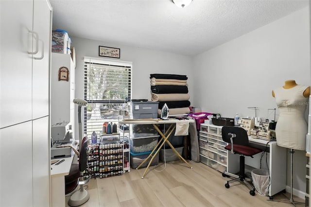home office with wood finished floors and a textured ceiling
