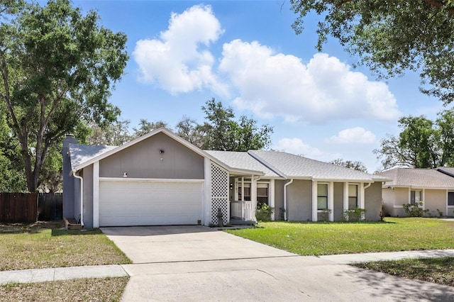 single story home featuring a chimney, concrete driveway, fence, a garage, and a front yard