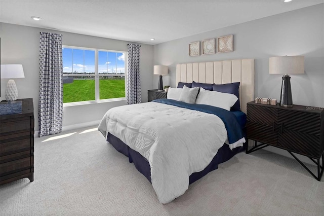 carpeted bedroom featuring baseboards and recessed lighting