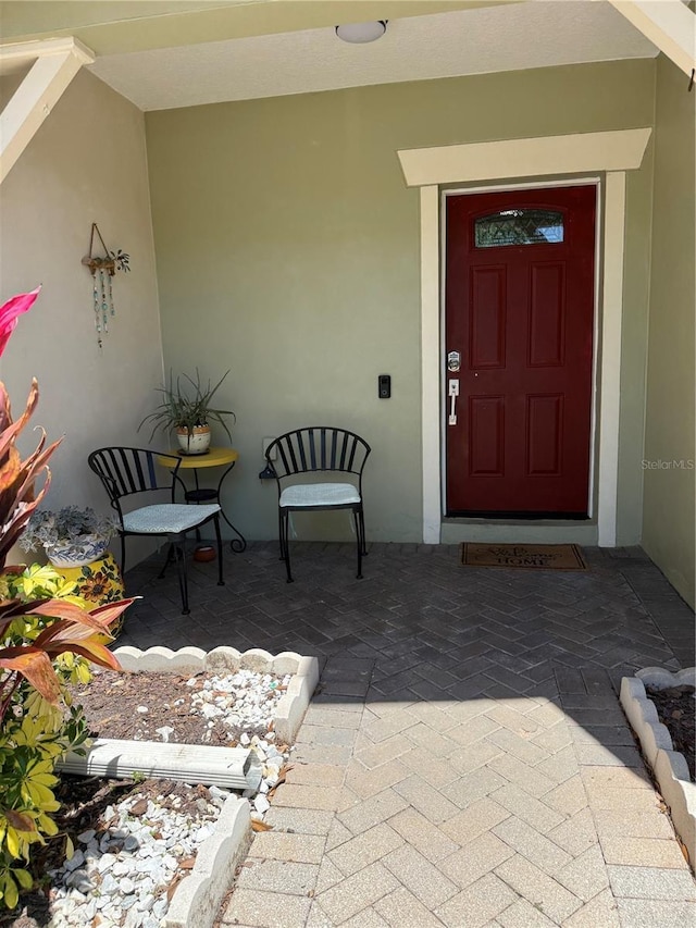 entrance to property with stucco siding