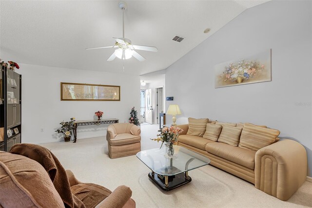 carpeted living area with visible vents, baseboards, a ceiling fan, and lofted ceiling