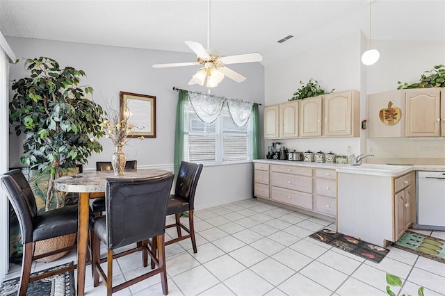 kitchen featuring ceiling fan, vaulted ceiling, dishwasher, light countertops, and light brown cabinets
