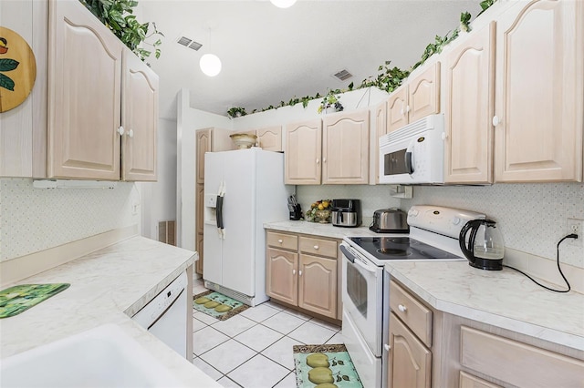 kitchen featuring white appliances, visible vents, light brown cabinets, and light countertops
