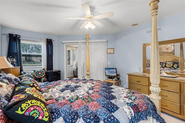 bedroom featuring a ceiling fan and a textured ceiling