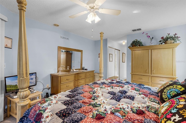 bedroom with a textured ceiling, a ceiling fan, and visible vents