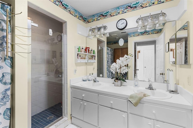full bathroom featuring a sink, double vanity, and a stall shower