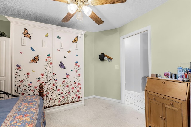 bedroom with a textured ceiling, baseboards, and ceiling fan