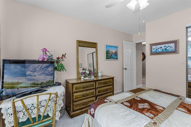 bedroom with a textured ceiling, baseboards, and a ceiling fan