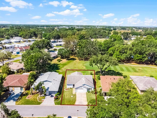 birds eye view of property with view of golf course and a residential view