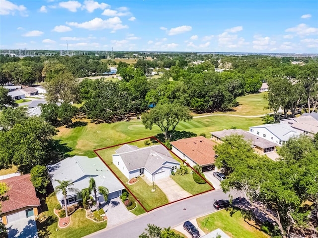 drone / aerial view with view of golf course and a residential view