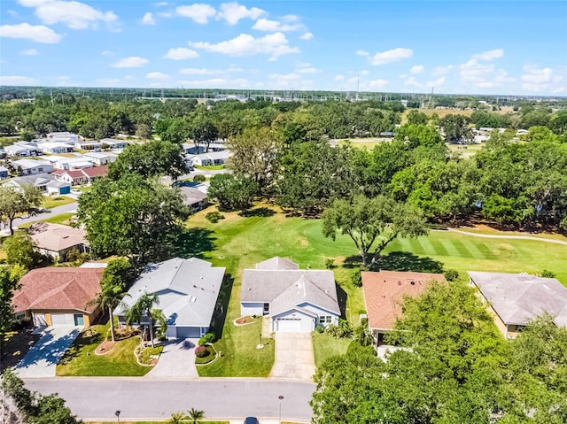 drone / aerial view featuring view of golf course and a residential view