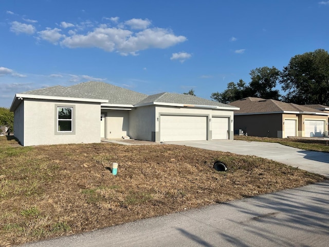 2310 Logsdon St, North Port, FL 34287 - ranch-style home with concrete driveway, an attached garage, and stucco siding