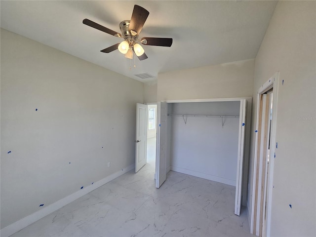 2310 Logsdon St, North Port, FL 34287 - unfurnished bedroom with a closet, light marble finish flooring, ceiling fan, and baseboards