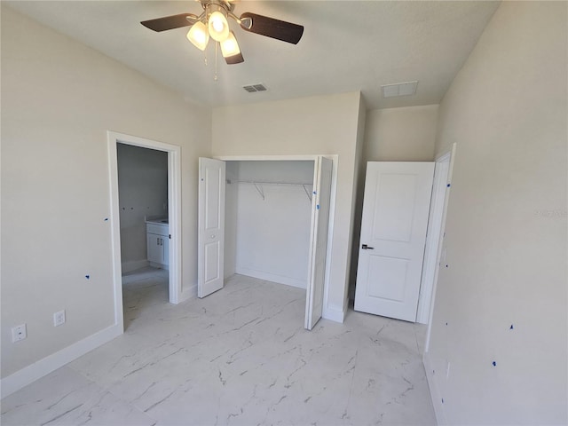 2310 Logsdon St, North Port, FL 34287 - unfurnished bedroom with light marble finish flooring, a closet, baseboards, and a ceiling fan