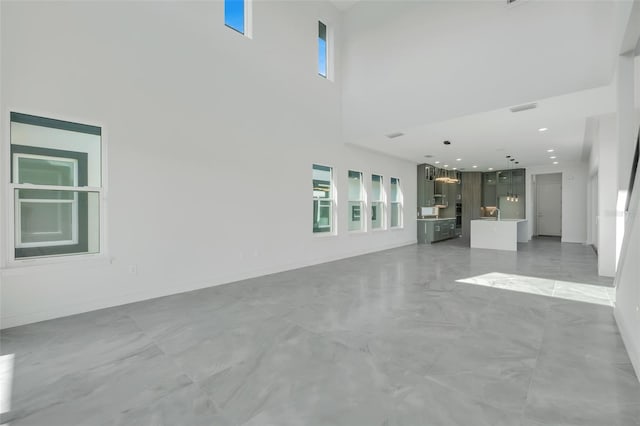 3024 Kensington Ave, Davenport, FL 33837 - unfurnished living room with a towering ceiling and marble finish floor
