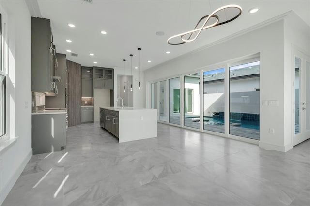 3024 Kensington Ave, Davenport, FL 33837 - kitchen with hanging light fixtures, light countertops, marble finish floor, and an inviting chandelier