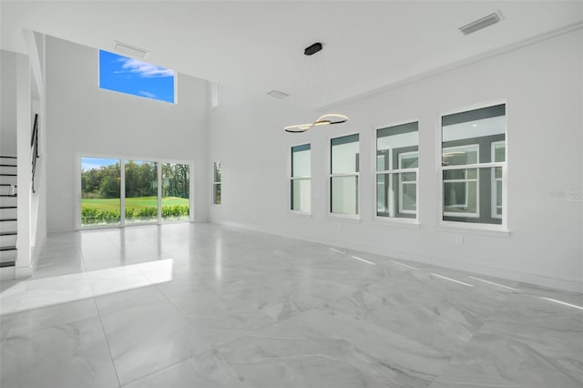 3024 Kensington Ave, Davenport, FL 33837 - unfurnished room with stairs, a towering ceiling, visible vents, and marble finish floor