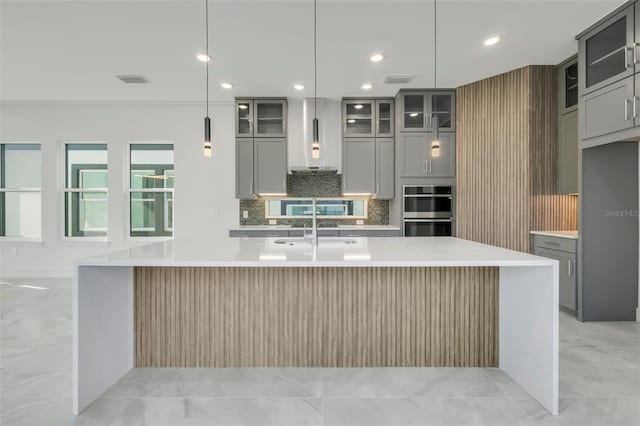 3024 Kensington Ave, Davenport, FL 33837 - kitchen featuring gray cabinets, wall chimney exhaust hood, and stainless steel double oven